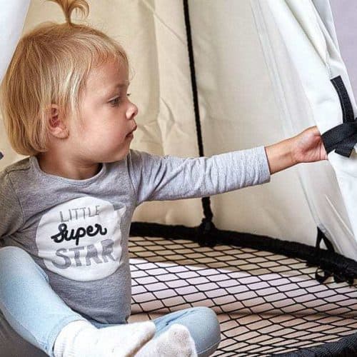 Barn leger i en Sort Sansegynge med et hvidt telt